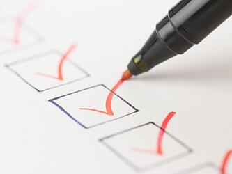 red pen checking off tick boxes